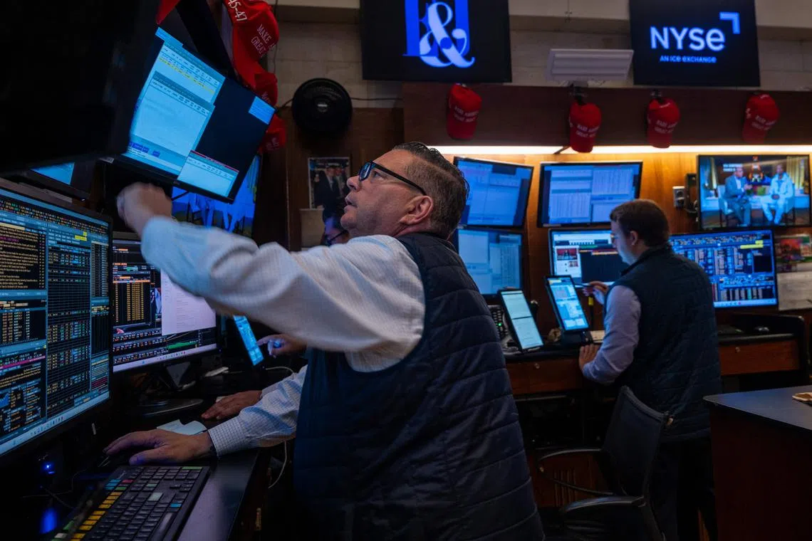 Traders work on the floor of the New York Stock Exchange, in New York City.