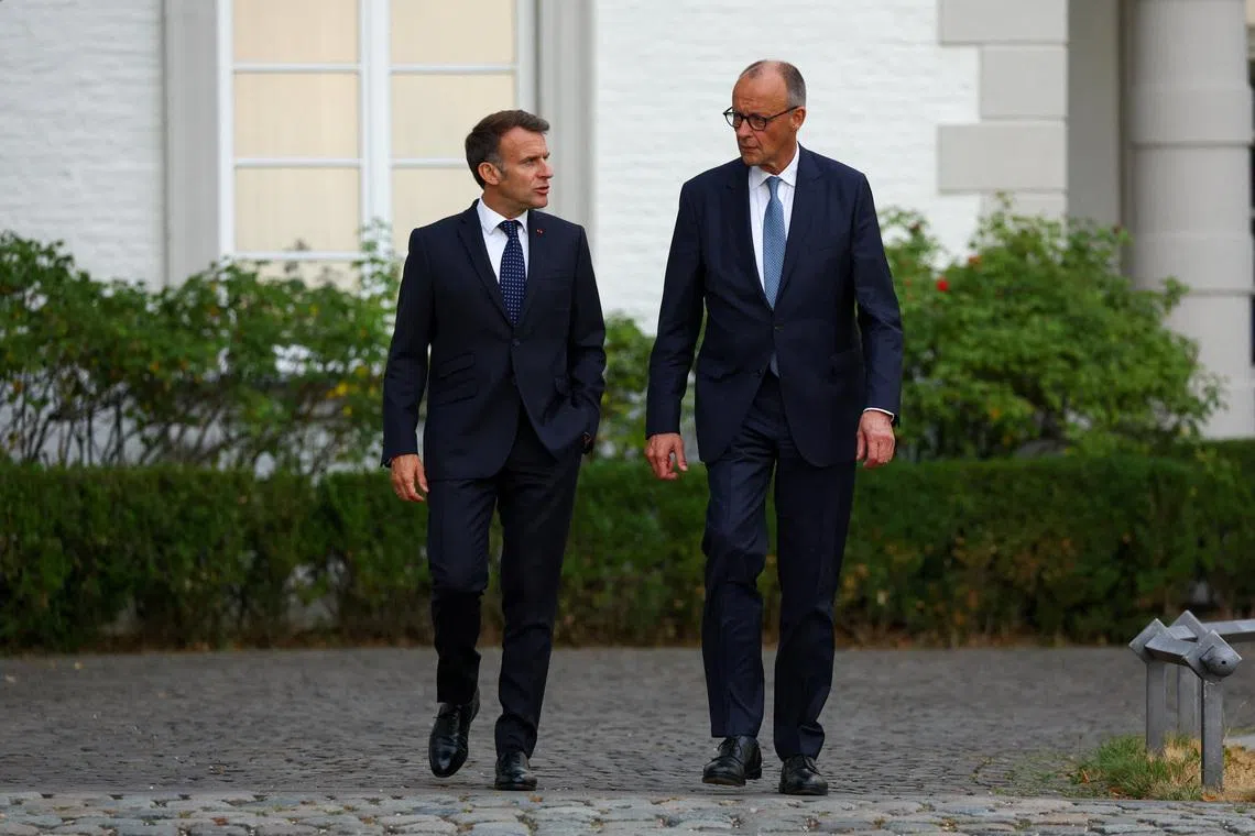 German Chancellor Friedrich Merz and French President Emmanuel Macron walk, on the day of their meeting at Grandhotel Schloss Bensberg, in Bensberg, Bergisch Gladbach, Germany, July 16, 2026. REUTERS/Thilo Schmuelgen