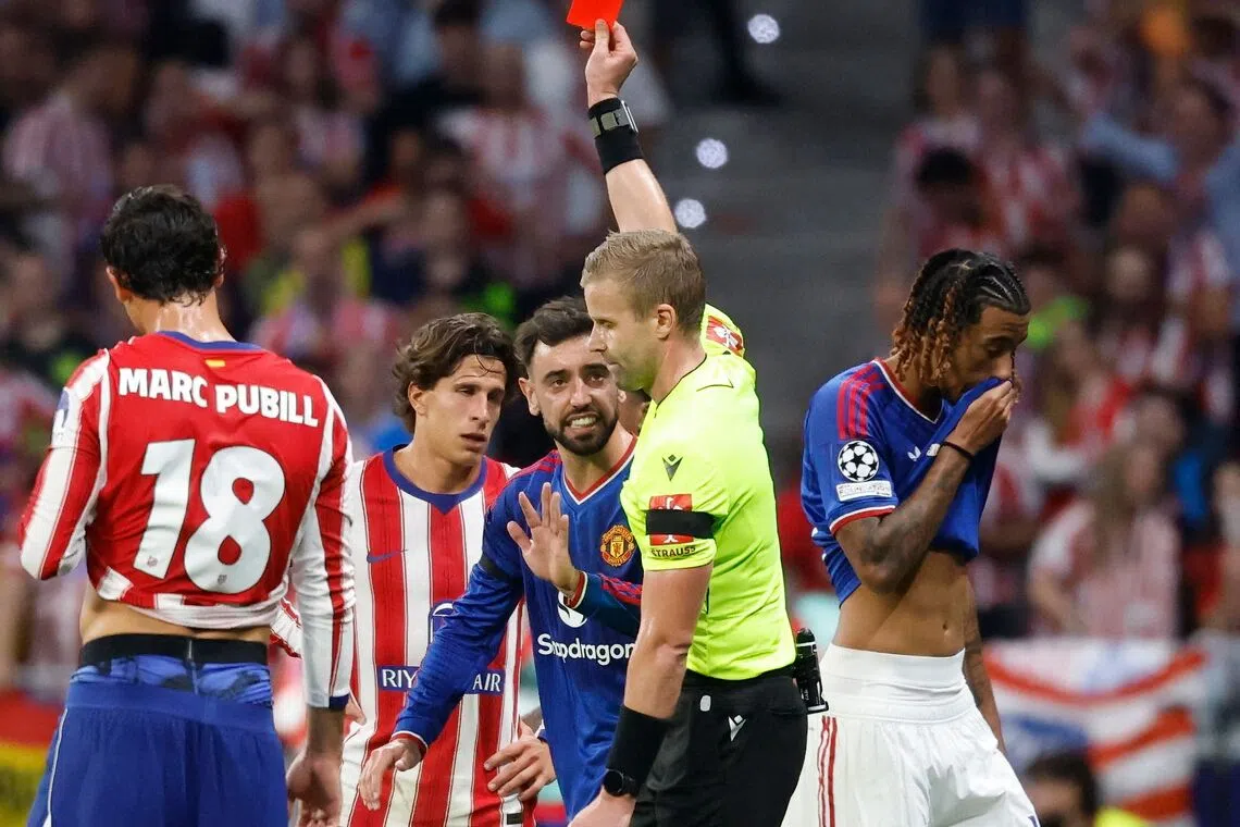 Swedish referee Glenn Nyberg shows a red card to Manchester United’s French defender Leny Yoro (right) during the match.