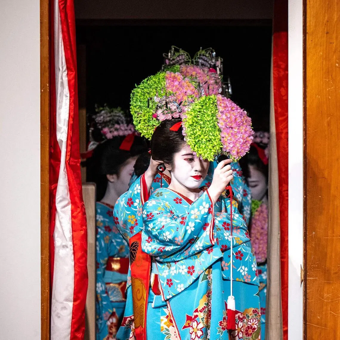 Geisha and maiko (apprentice geisha) take part in a rehearsal for the annual "Miyako Odori" -- which means "capital city dance" in Japanese, at the Gion Kobu Kaburenjo in Kyoto on March 31, 2026. Against a backdrop of blooming cherry blossoms, a group of geishas elegantly shuffle onto a stage in Japan's Kyoto city to begin a centuries-old performance celebrating the arrival of spring.
Dressed in sky blue kimonos emblazoned with flowers, the dancers twist and twirl in unison in front of hundreds of spectators eager to see the annual "Miyako Odori" in the nation's spectacular ancient capital. (Photo by Philip FONG / AFP)