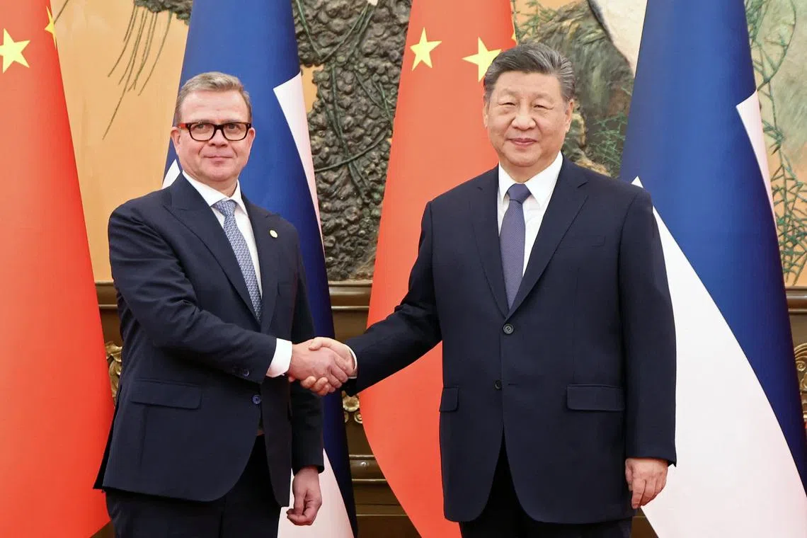 Chinese President Xi Jinping and Finland's Prime Minister Petteri Orpo shake hands at the Great Hall of the People in Beijing, China January 27, 2026. China Daily via REUTERS