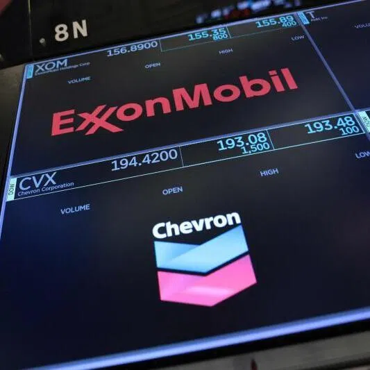 ExxonMobil and Chevron company logos displayed on the floor of the New York Stock Exchange in New York City. The oil giants released blowout profits last week, with Chevron posting its highest quarterly earnings in at least six years.