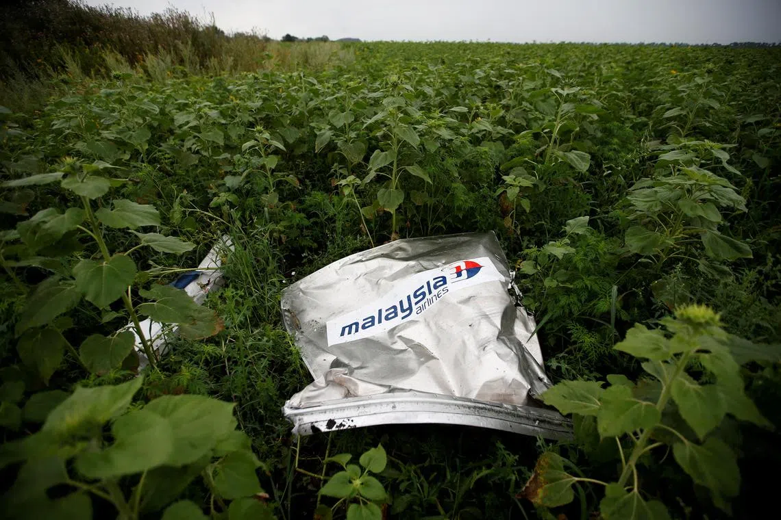 FILE PHOTO: Debris from a Malaysian Airlines Boeing 777 that crashed on Thursday lies on the ground near the village of Rozsypne in the Donetsk region July 18, 2014. REUTERS/Maxim Zmeyev//File Photo