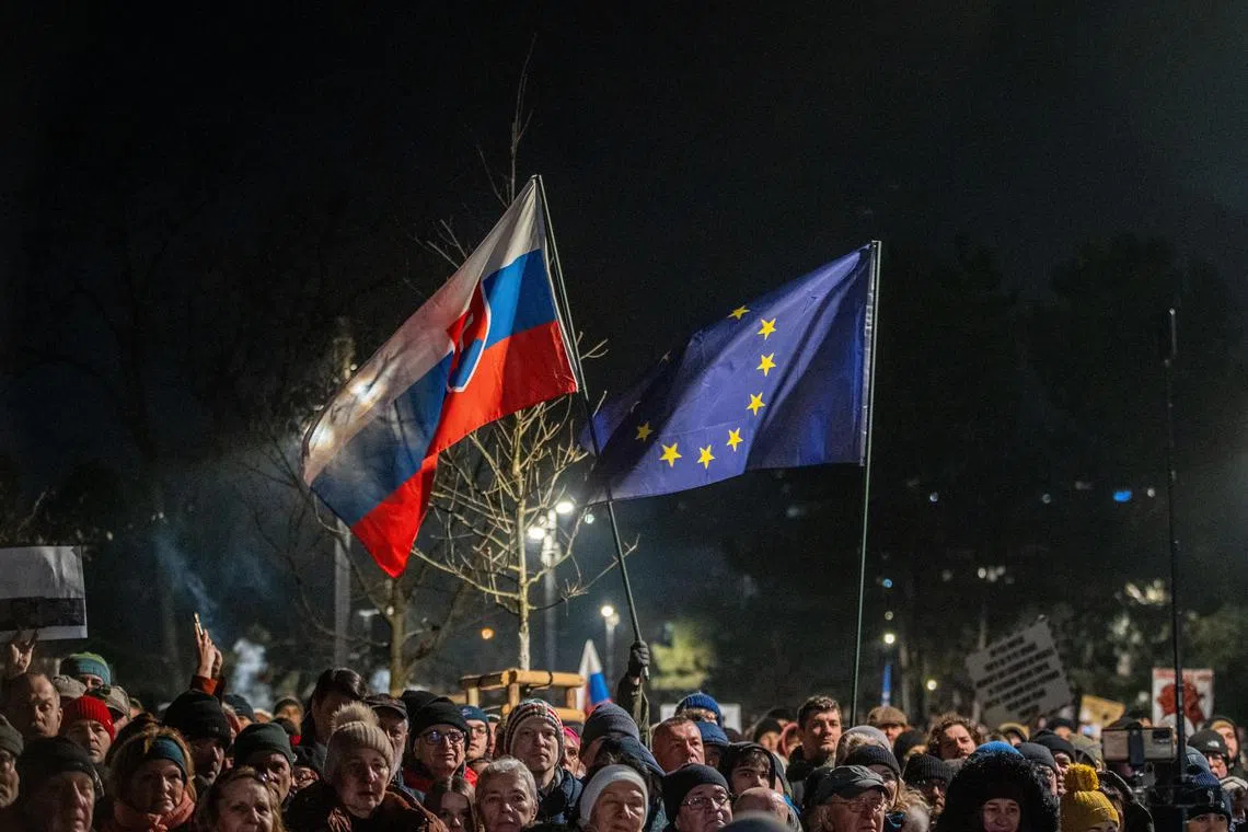 People wave Slovak and EU flags during a demonstration against Slovak Prime Minister Robert Fico's government in Bratislava, on Jan 24.