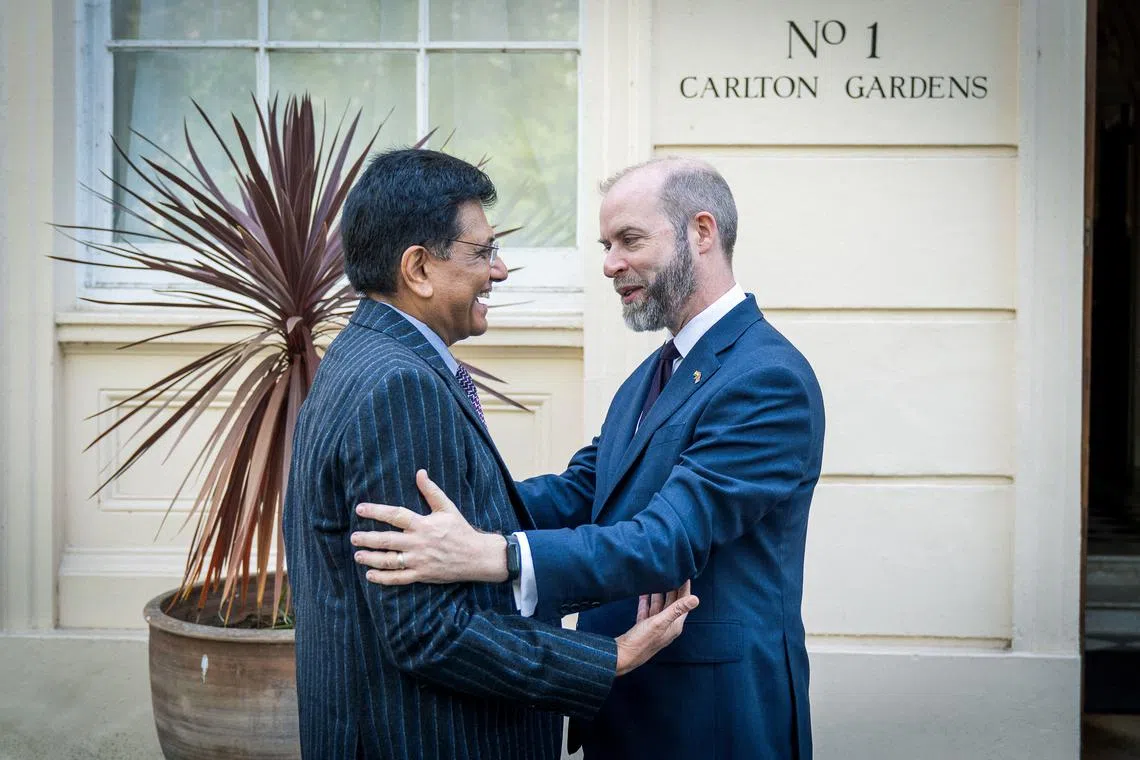 FILE PHOTO: Britain's Secretary of State for Business and Trade Jonathan Reynolds welcomes Indian Minister of Commerce and Industry Piyush Goyal for trade talks, in London, Britain, April 28, 2025. Department for Business and Trade/Handout via REUTERS