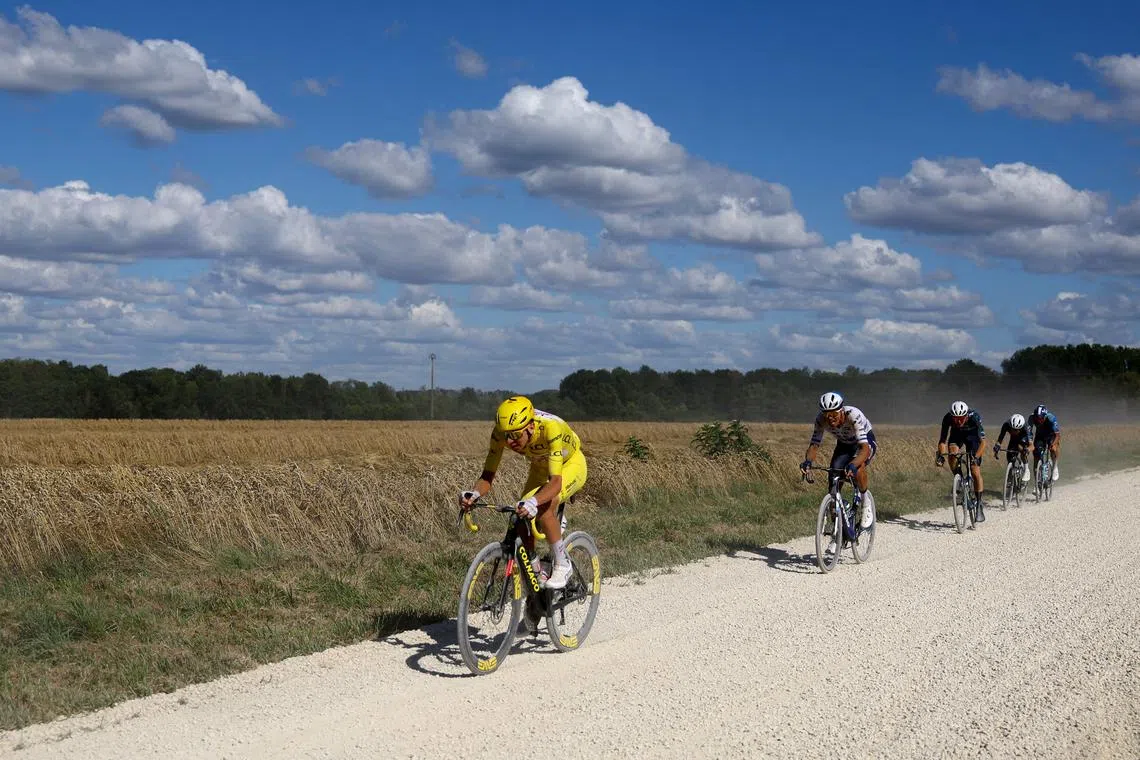 Cycling - Tour de France - Stage 9 - Troyes to Troyes - Troyes, France - July 7, 2024 UAE Team Emirates' Tadej Pogacar in action with riders during stage 9 REUTERS/Molly Darlington