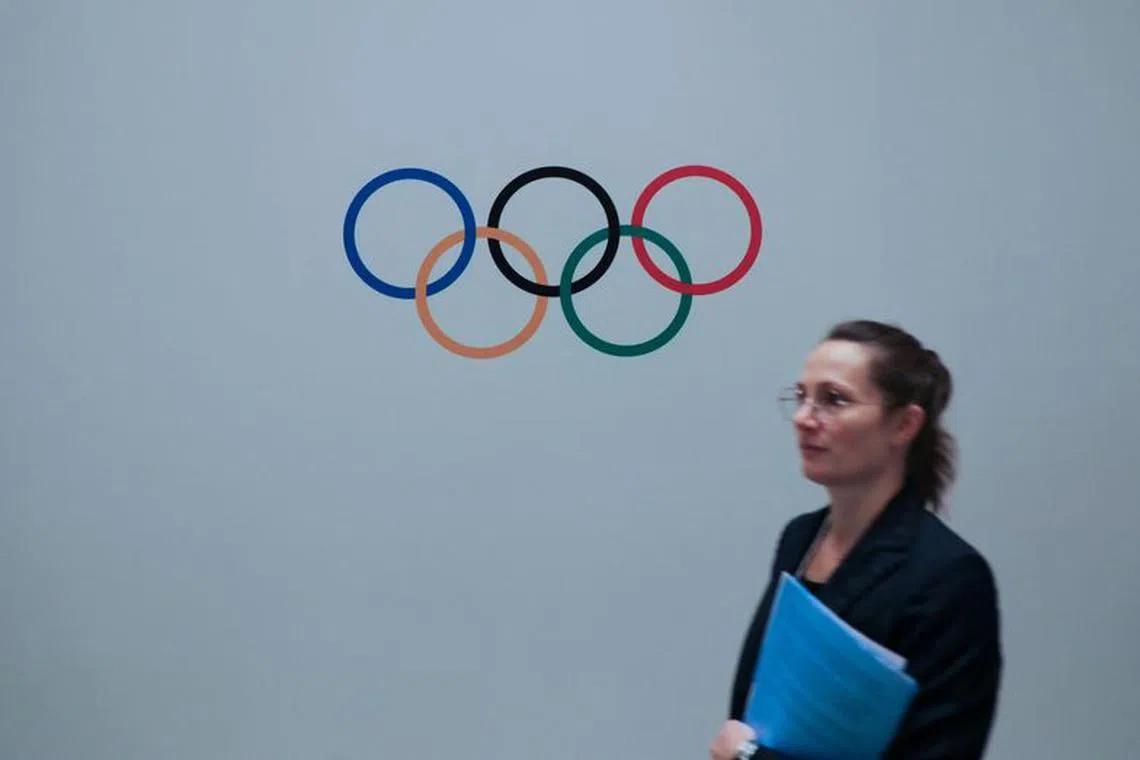 A woman walks past a logo of Olympics during a meeting of International Olympic Committee (IOC), ahead of the 141st IOC Session, in Mumbai, India, October 13, 2023. REUTERS/ Niharika Kulkarni/file photo