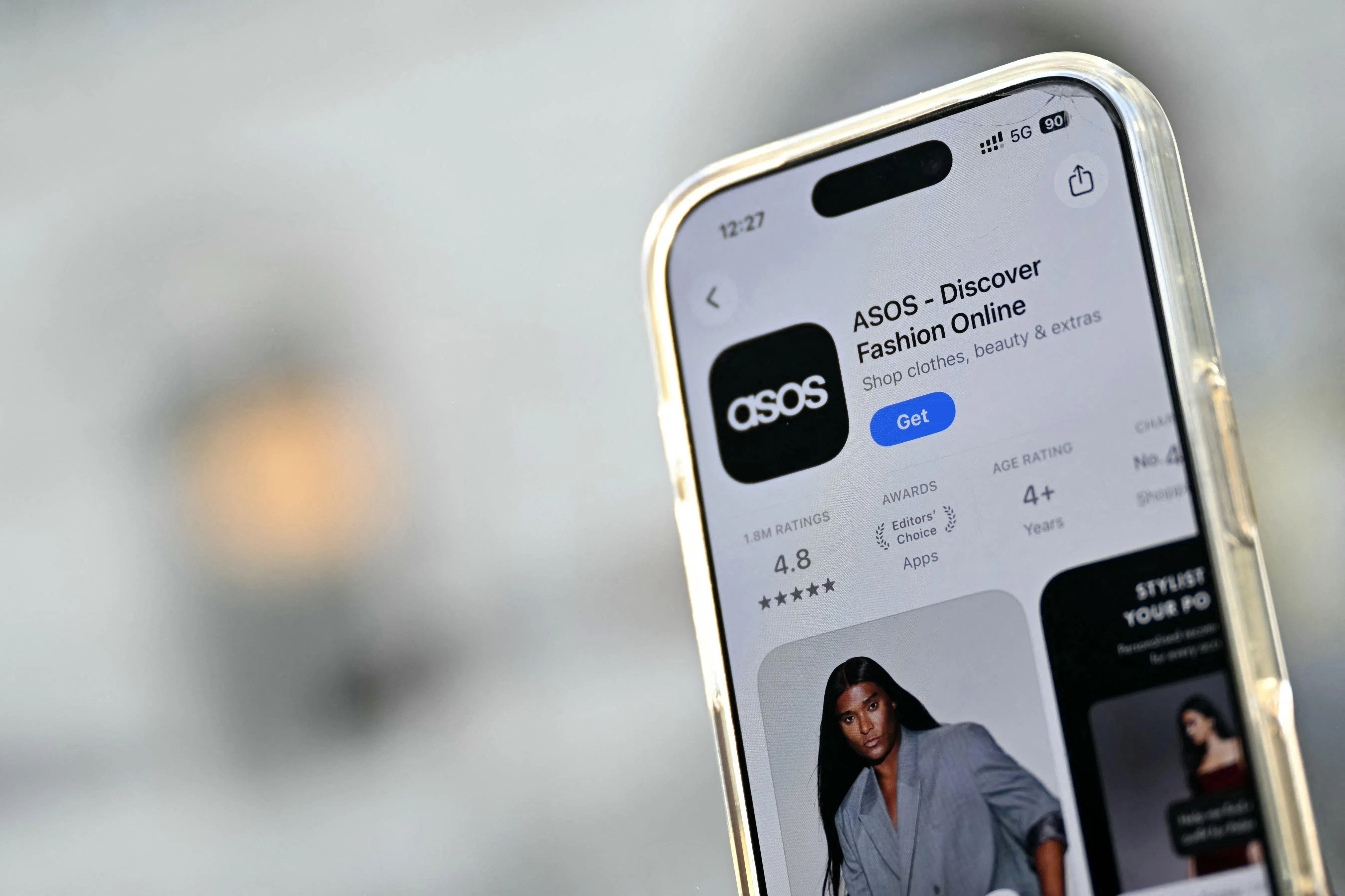 The Asos app is seen ready for download from an app store on an Apple i-phone in London on October 6, 2026. UK online fashion giant Asos saw its share price slump more than 10 percent in London trading Tuesday, October 6, after customers reportedly received a mobile notification claiming its systems had been hacked. (Photo by JUSTIN TALLIS / AFP)