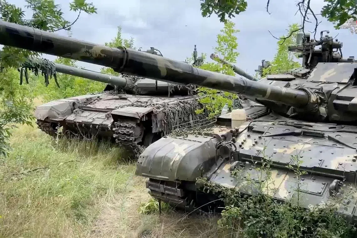 A still image from video shows tanks which are said to have been handed over by the Wagner mercenary group to Russia's regular armed forces.