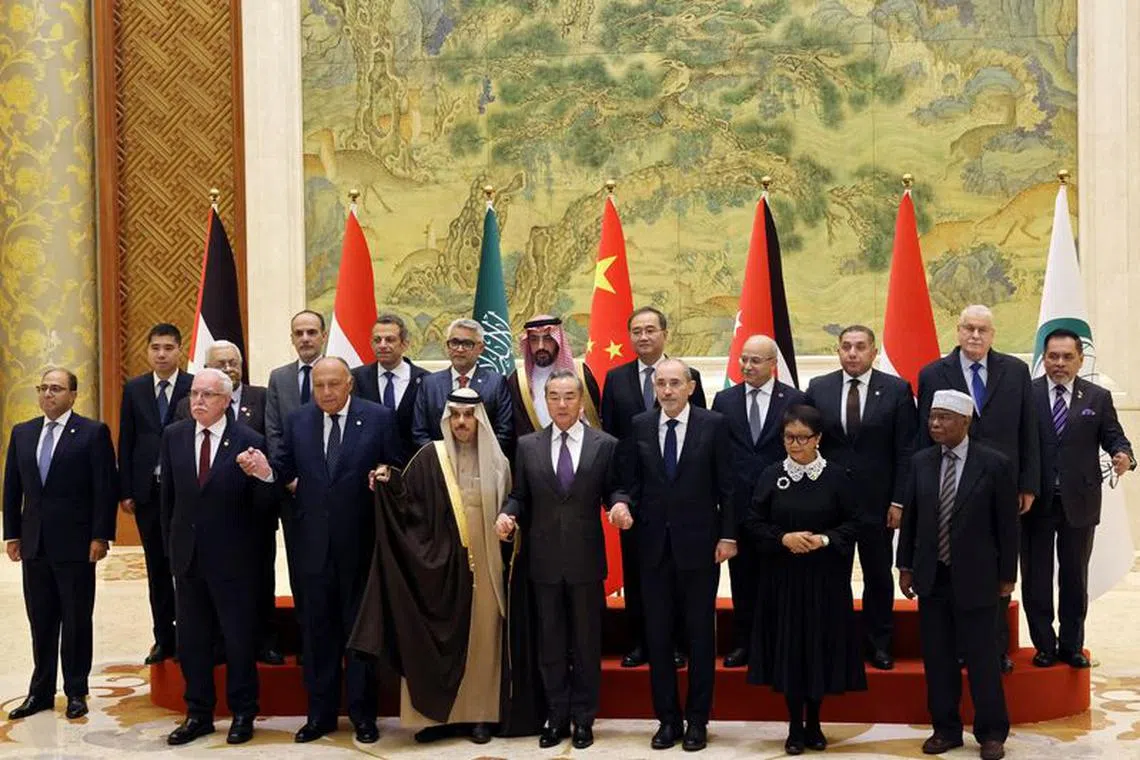 Chinese Foreign Minister Wang Yi attends a family photo session with Saudi Foreign Minister Prince Faisal bin Farhan Al Saud, Jordanian Deputy Prime Minister and Foreign Minister Ayman Safadi, Egyptian Foreign Minister Sameh Shoukry, Indonesian Foreign Minister Retno Marsudi, Palestinian Foreign Minister Riyad Al-Maliki and Organisation of Islamic Cooperation (OIC) Secretary-General Hissein Brahim Taha at the Diaoyutai State Guesthouse in Beijing, China November 20, 2023. REUTERS/Florence Lo/Pool/File photo