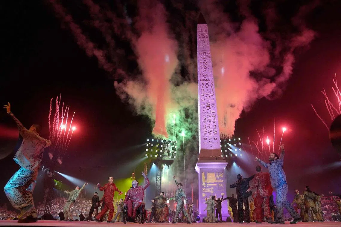 Artists performing the "Paradoxe" show at the Place de la Concorde around the Obelisque de Louxor (Luxor Obelisk) during the Paris 2024 Paralympic Games Opening Ceremony in Paris on Aug 28, 2024.