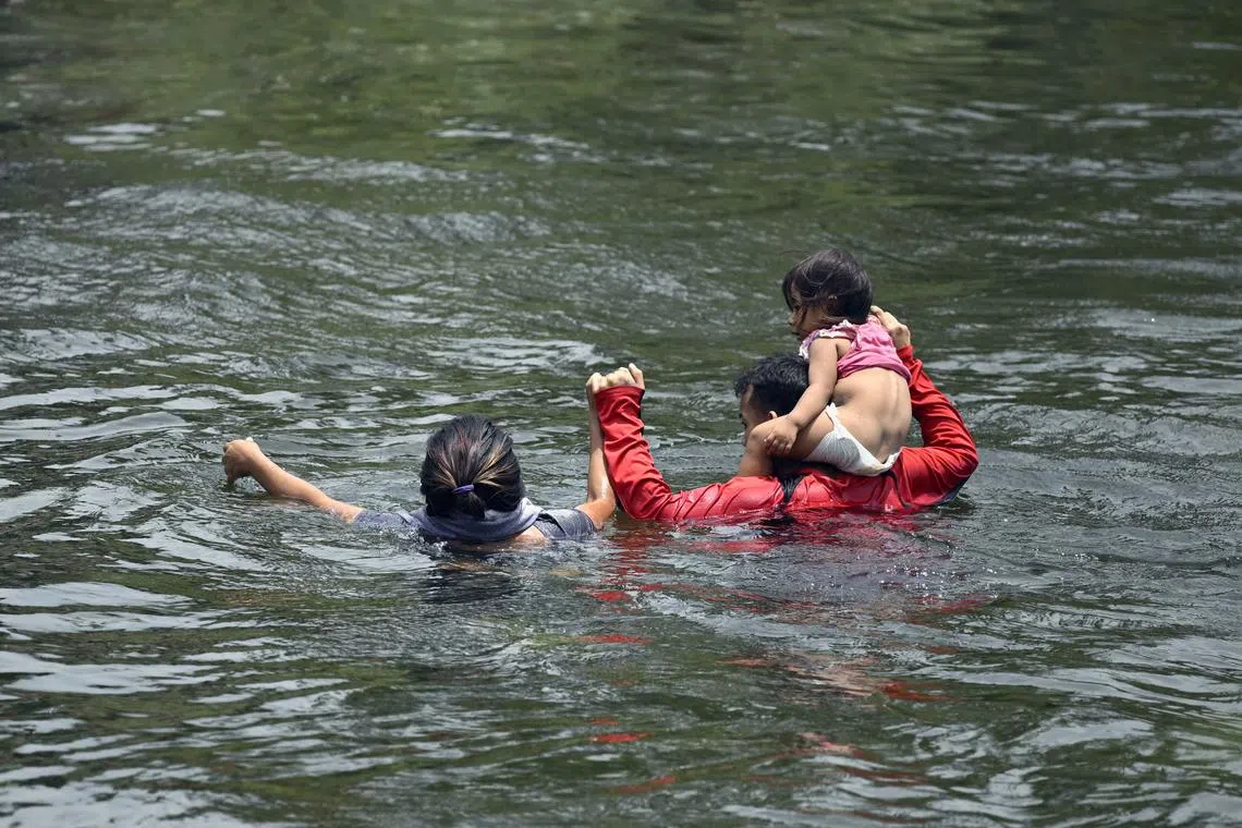 Migrants cross the Rio Grande River from Mexico as they try to get to the US.