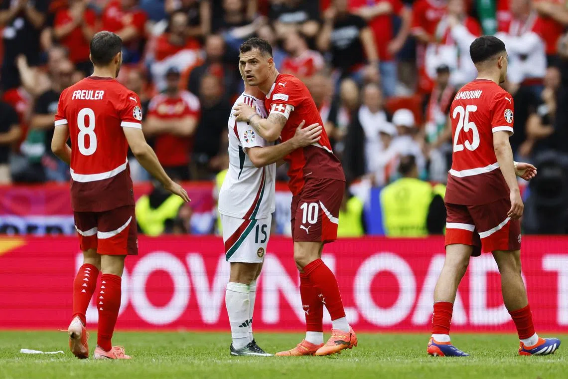 Soccer Football - Euro 2024 - Group A - Hungary v Switzerland - Cologne Stadium, Cologne, Germany - June 15, 2024 Hungary's Laszlo Kleinheisler and Switzerland's Granit Xhaka after the match REUTERS/Wolfgang Rattay