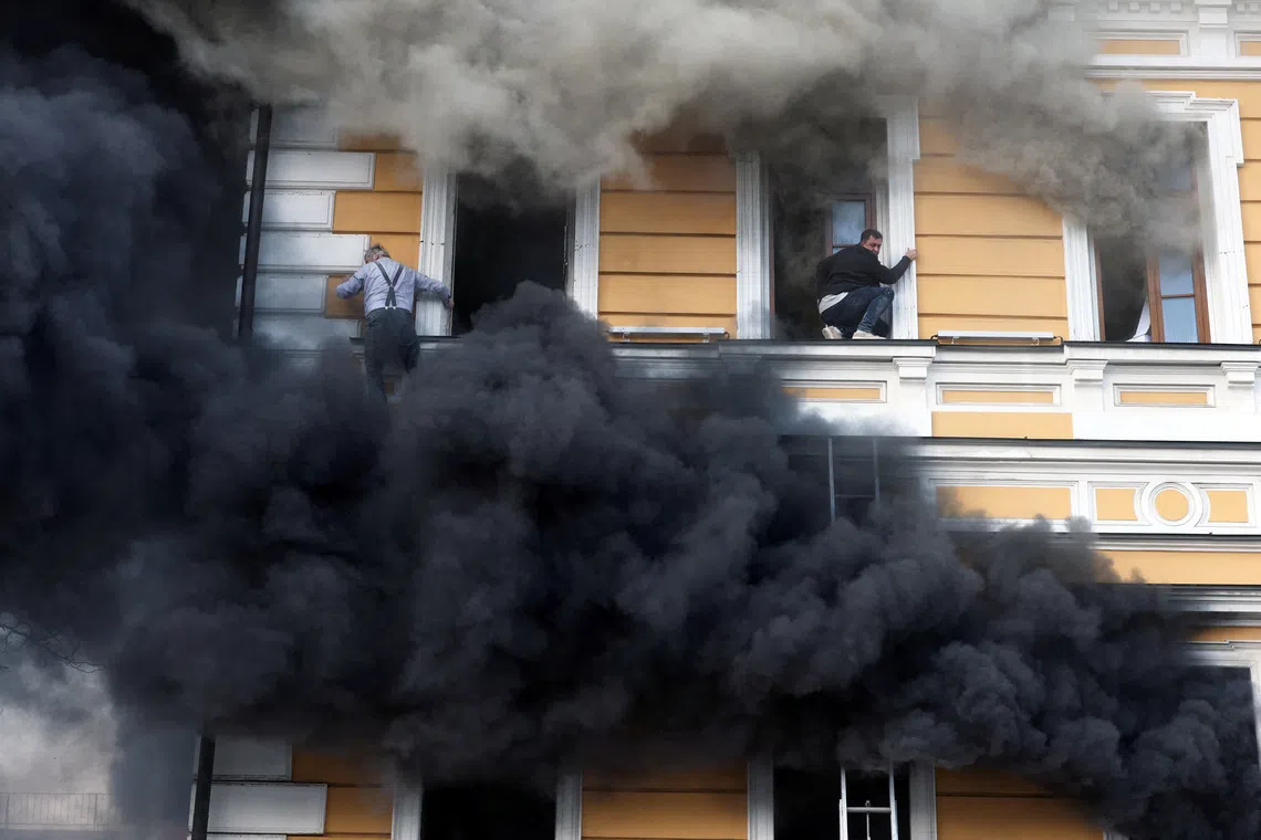 Residents try to evacuate an administrative building hit by a Russian jet-powered drone strike, amid Russia's attack on Ukraine, in Kyiv, Ukraine, September 28, 2026. REUTERS/Alina Smutko TPX IMAGES OF THE DAY