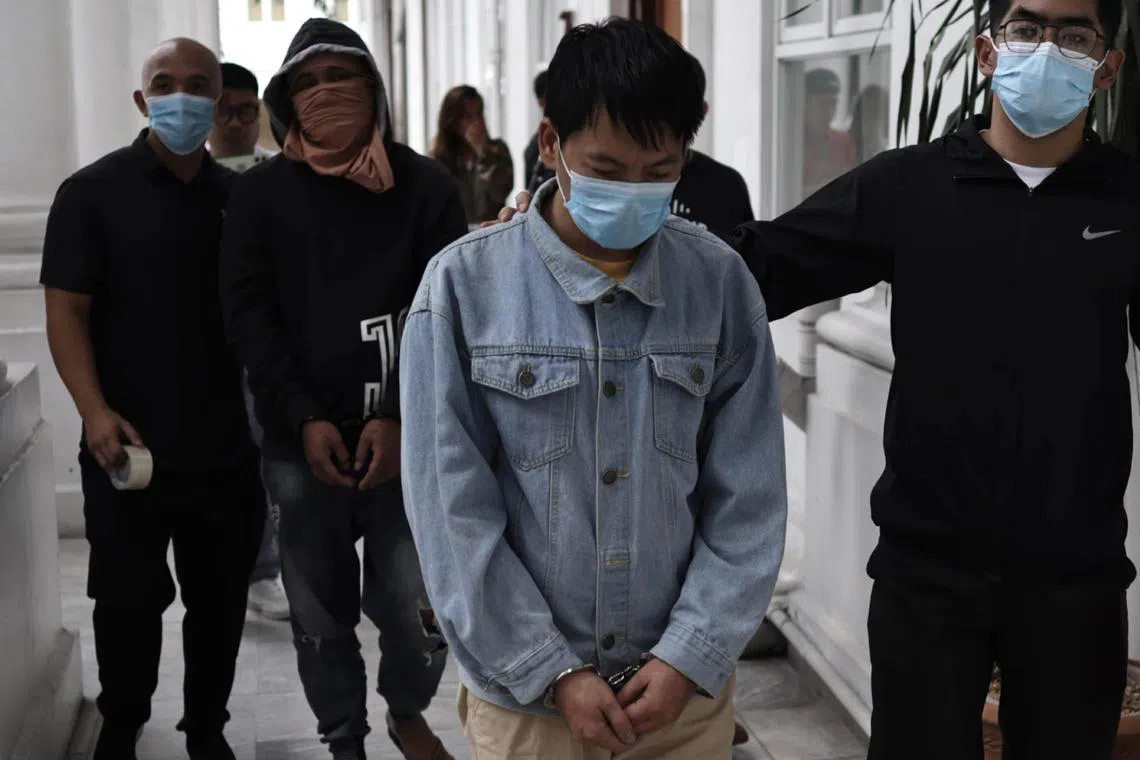 Chinese national Deng Yuanqing (centre) is escorted inside the Department of Justice office in Manila, Philippines.