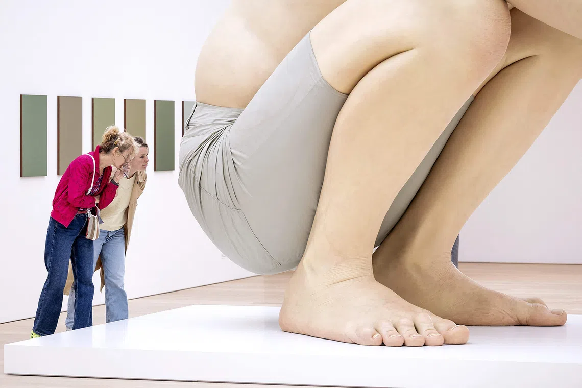 Visitors look at the artwork 'Boy' by Australian sculptor Ron Mueck during the press opening for the exhibition 'Celebrating the Icons of Art' at the Voorlinden Museum in Wassenaar on September 10, 2026. (Photo by Robin van Lonkhuijsen / ANP / AFP) / Netherlands OUT / RESTRICTED TO EDITORIAL USE - MANDATORY MENTION OF THE ARTIST UPON PUBLICATION - TO ILLUSTRATE THE EVENT AS SPECIFIED IN THE CAPTION