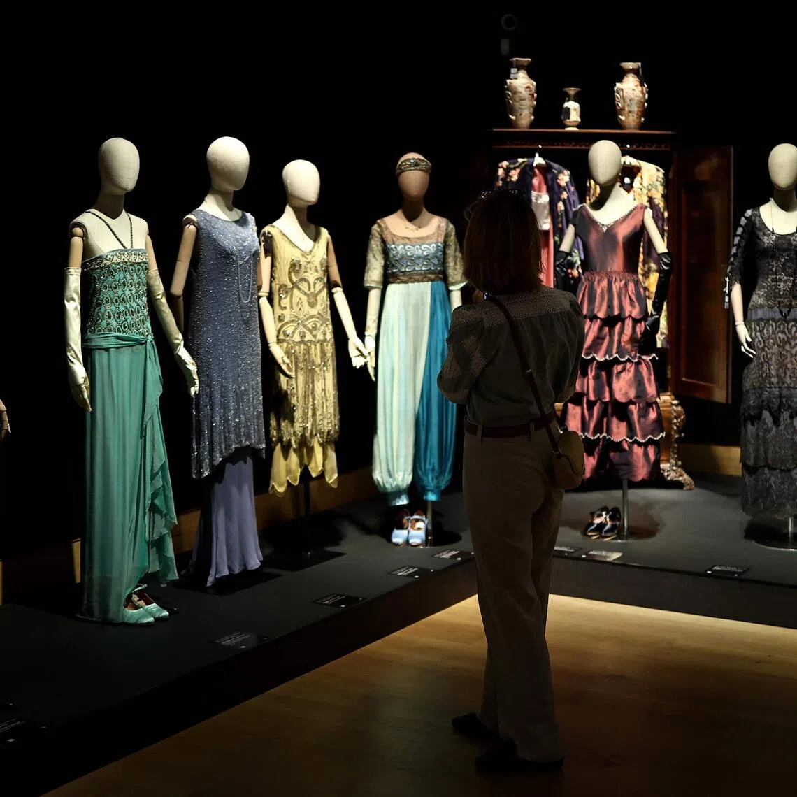 A collection of dresses belonging to characters from the Downton Abbey TV and film series during a press preview for an exhibition of of props, costumes and other items from the franchise before they go to auction, in central London on Aug 8, 2025. 