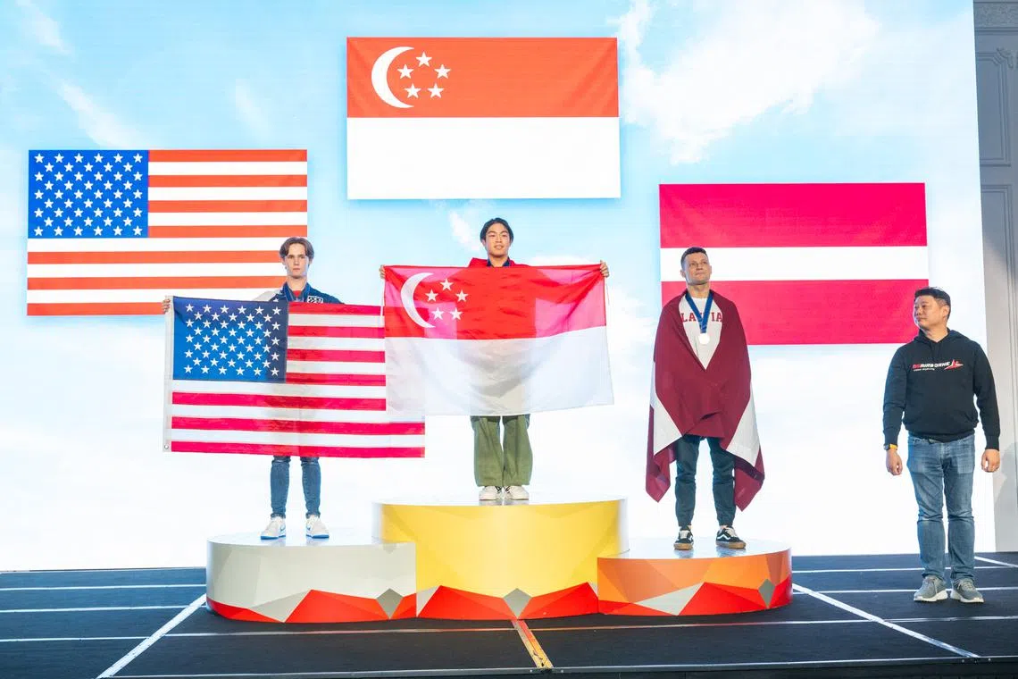 Singapore's Kai Minejima-Lee (centre) clinched the solo freestyle open gold at the World Cup of Indoor Skydiving.