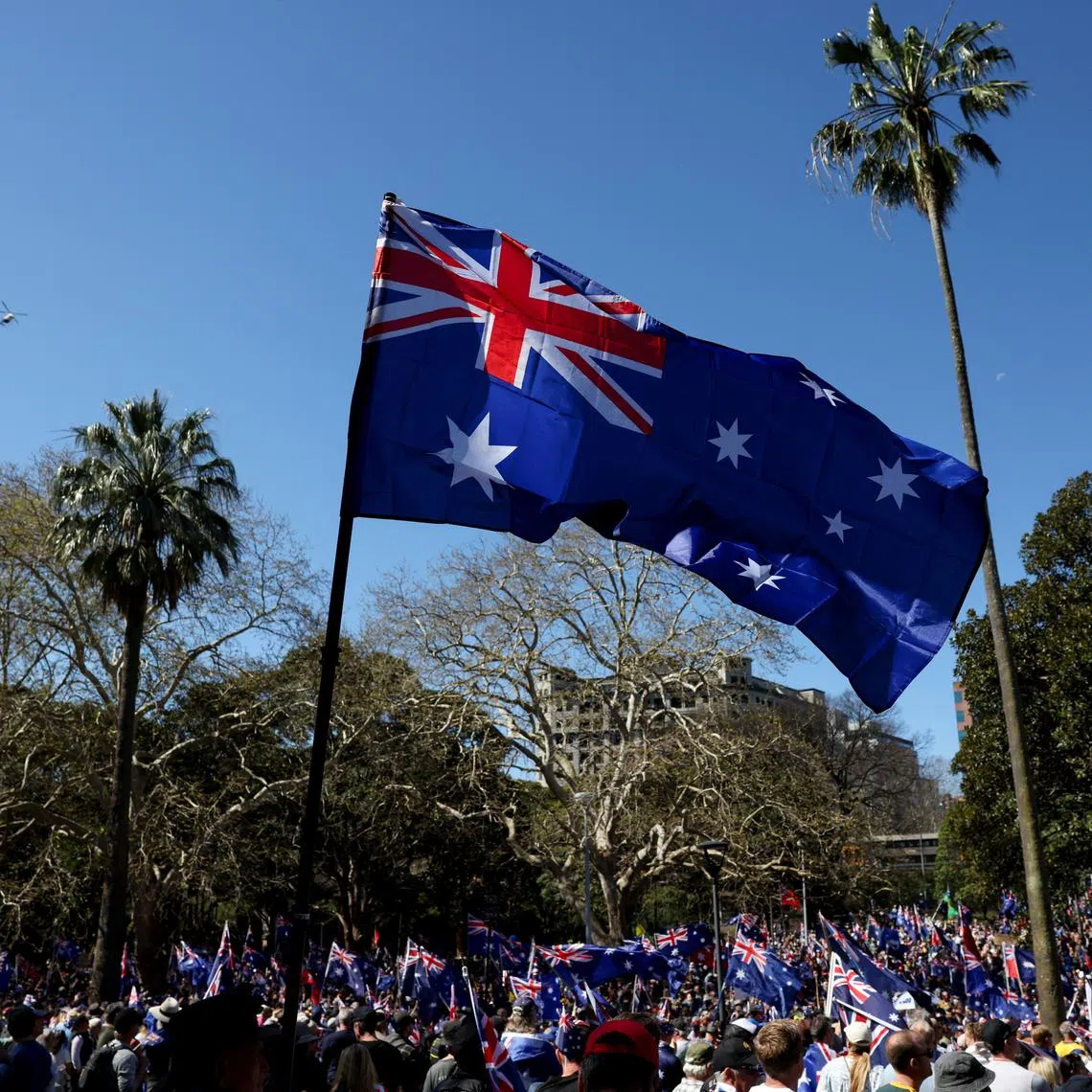 Demonstrators carry Australian flags during the 'March for Australia' anti-immigration rally, in Sydney, Australia, on Aug 31.