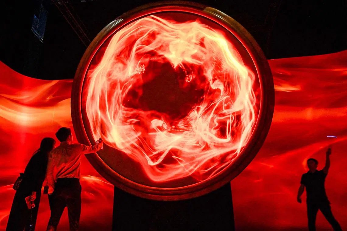 TOPSHOT - People visit the exhibition "Harry Potter: Visions of Magic interactive" at Resort World Sentosa in Singapore on November 20, 2024. (Photo by Roslan RAHMAN / AFP)