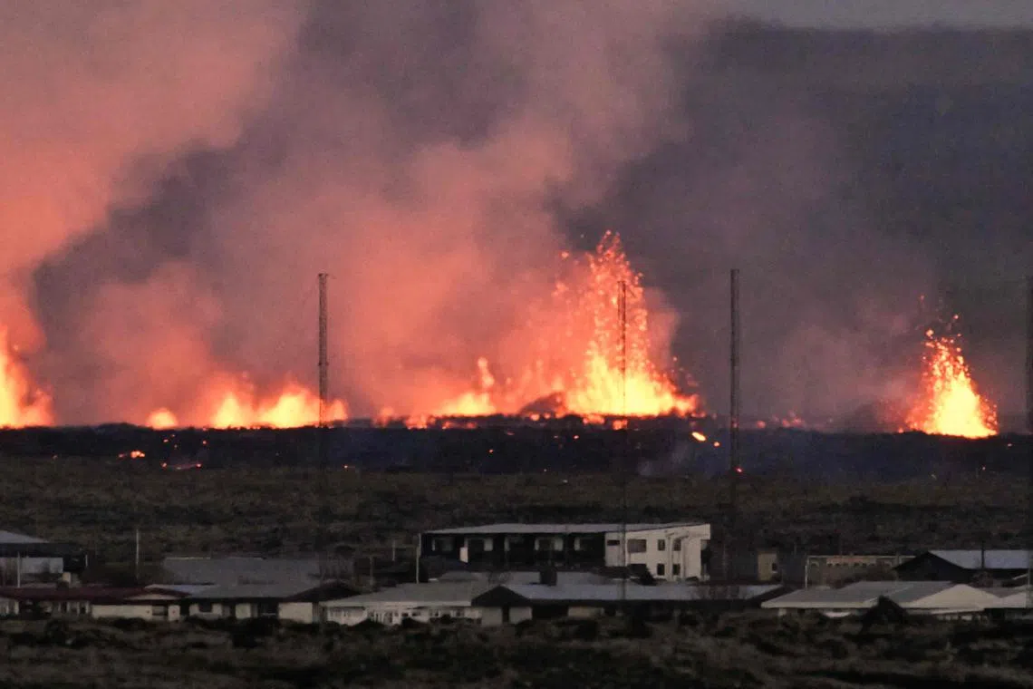 Lava explosions are seen near residential buildings in the Icelandic town of Grindavik.