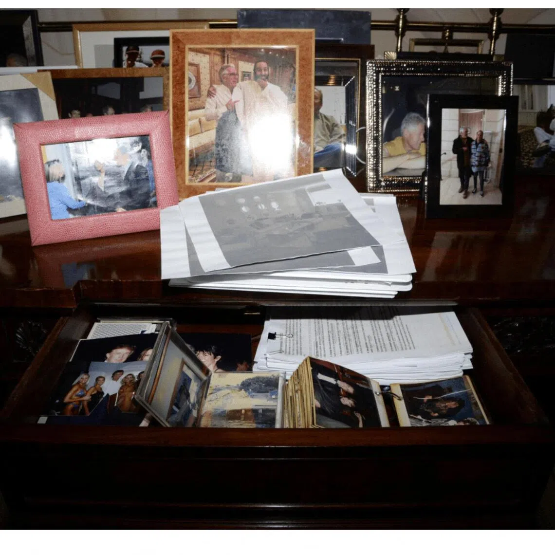 A view of drawers and framed photos, including of US President Donald Trump, in Jeffrey Epstein's Manhattan home. 