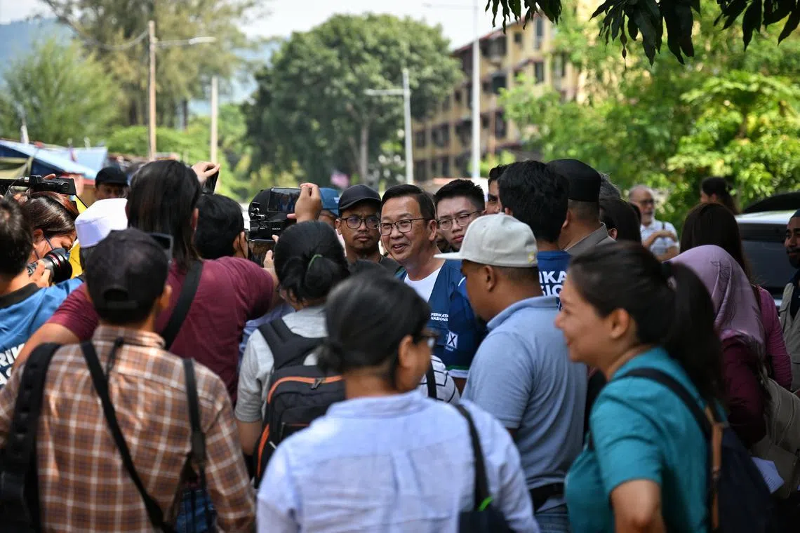 Gerakan president Dominic Lau (centre) speaking to fishermen from Sungei Batu on Aug 4, 2023.