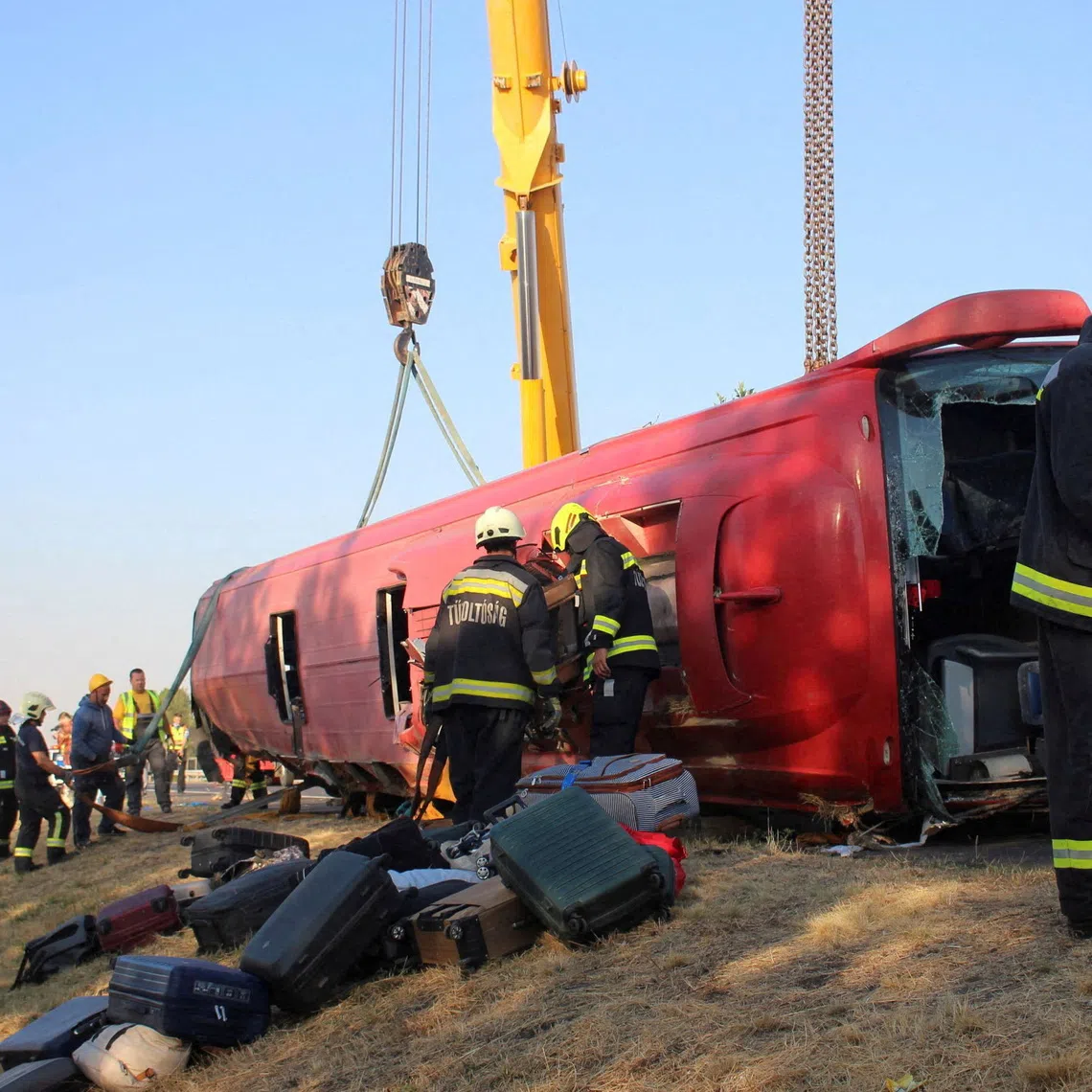 Firefighters work at the scene of a deadly accident, where a Polish bus carrying tourists veered off the motorway and overturned, near Mezokeresztes, Hungary, in this handout image released on August 16, 2026. Balazs Toth/Mezokovesd Kepekben/Handout via REUTERS