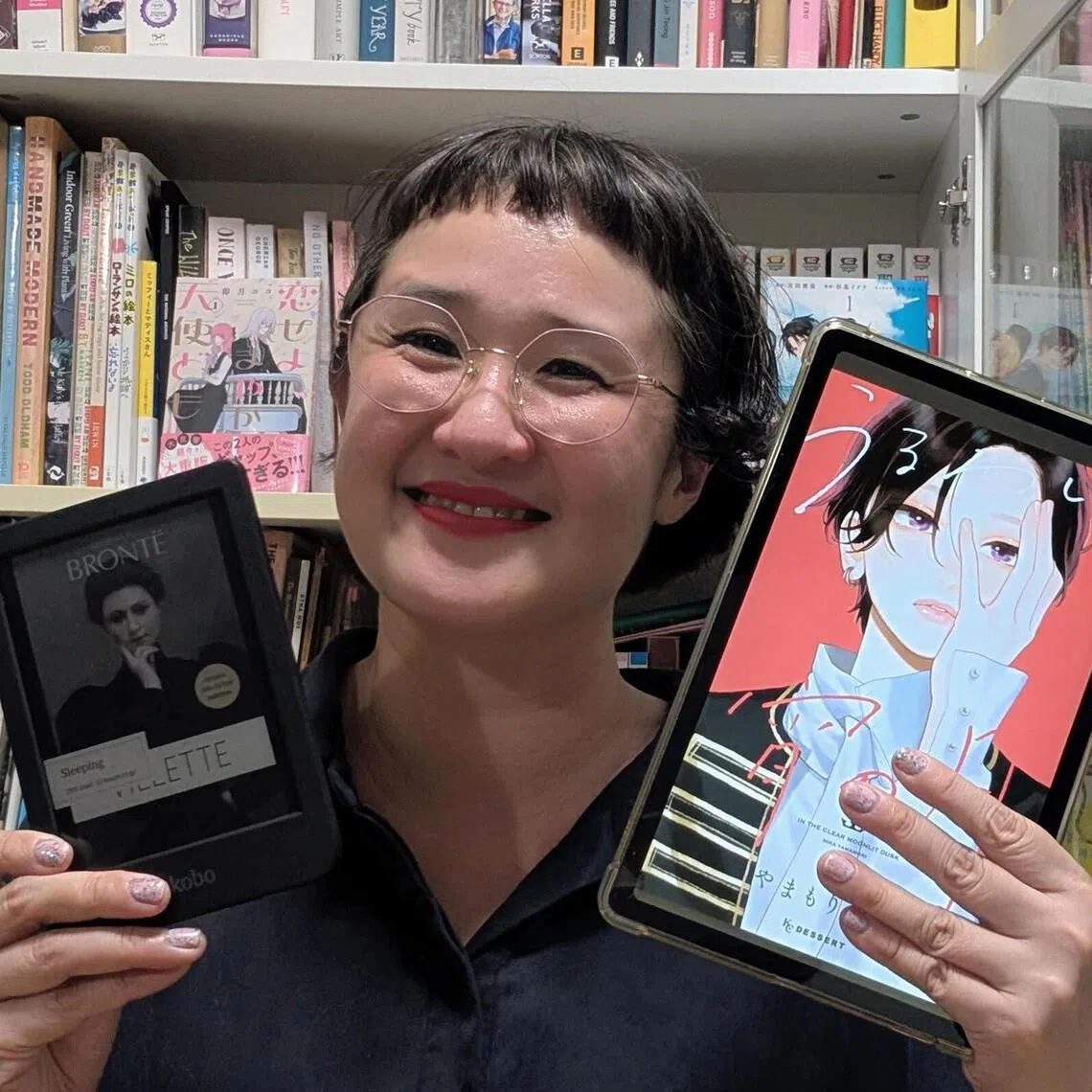 Ms Natalie Tan with her current reads – Charlotte Bronte’s Vilette on her Kobo, and romance manga In The Clear Moonlit Dusk by Mika Yamamori on her tablet. 