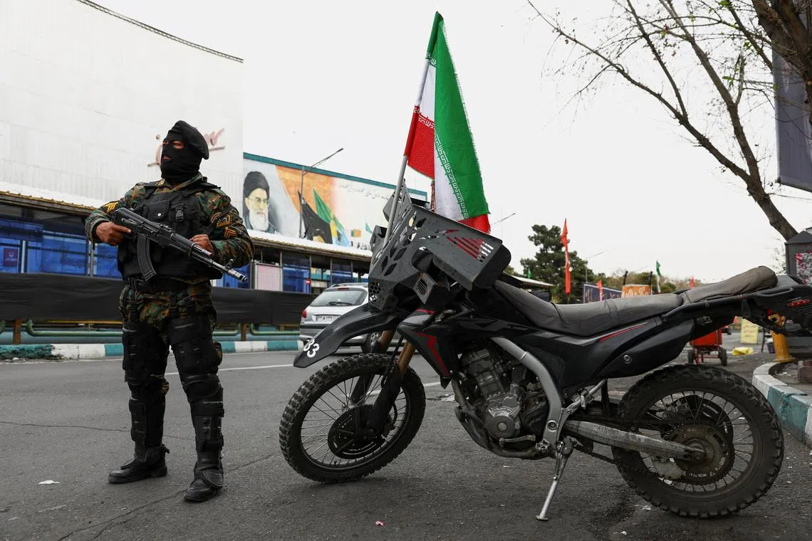 A member of a police force stands guard on a street, amid the U.S.-Israeli conflict with Iran, in Tehran, Iran, March 23, 2026. Majid Asgaripour/WANA (West Asia News Agency) via REUTERS