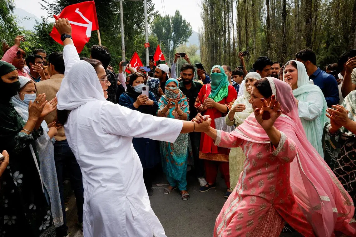 Supporters of the Jammu and Kashmir National Conference party celebrate outside the vote counting centre on the day of the assembly election results in Srinagar on Oct 8.
