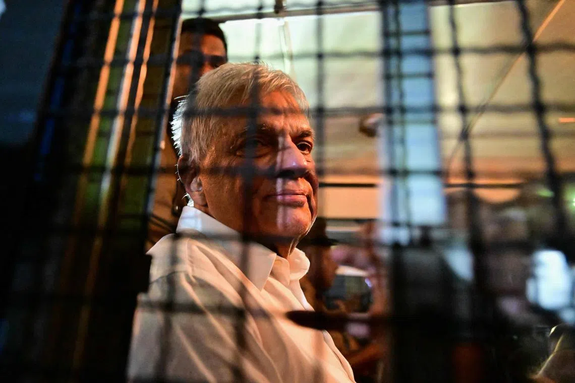 Sri Lanka's former president Ranil Wickremesinghe looks on as he sits in a prison bus in Colombo on Aug 22, 2025.
