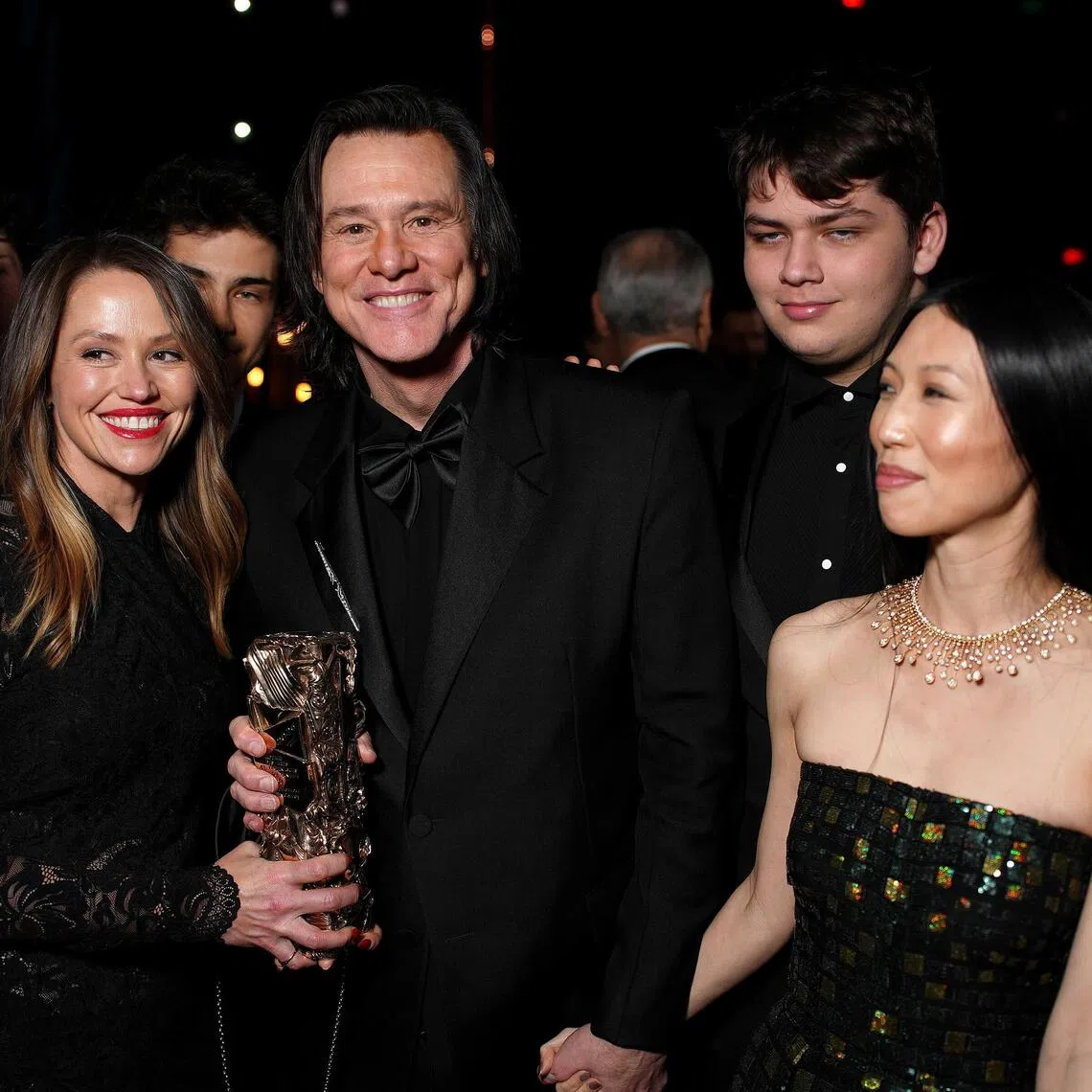 Jim Carrey (centre) with his daughter Jane (second from left), grandson Jackson and girlfriend Min Ah at the Cesar film awards in Paris in February.