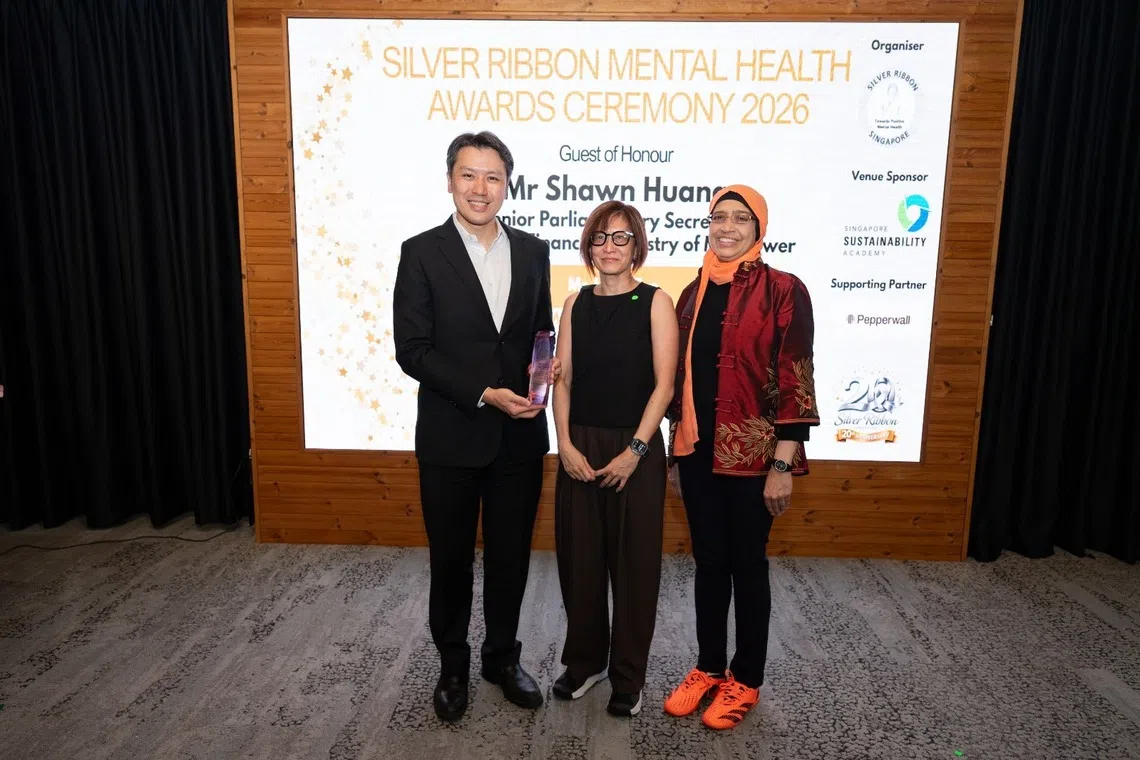 The Straits Times’ senior health correspondent Joyce Teo (centre) received the Media Excellence in Mental Health Awareness Award from Senior Parliamentary Secretary for Finance and Manpower Shawn Huang (left) and Fatimah Lateef (right), President of Silver Ribbon (Singapore).