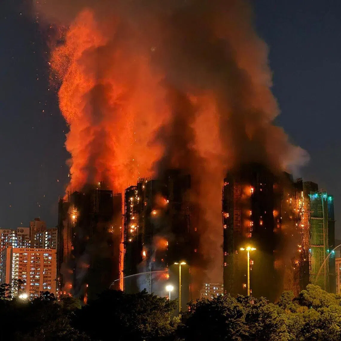 (FILES) Thick smoke and flames rise as a major fire engulfs several apartment blocks at the Wang Fuk Court residential estate in Hong Kong's Tai Po district on November 26, 2025. A devastating fire that ripped through a Hong Kong apartment complex last year and killed 168 people was "preventable", lawyers told a committee investigating the blaze in closing statements on July 17, 2026. (Photo by Yan ZHAO / AFP)