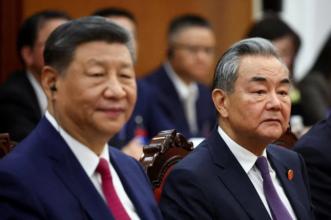 FILE PHOTO: Chinese President Xi Jinping and Foreign Minister Wang Yi attend a meeting with Vietnam's National Assembly Chairman Tran Thanh Man (not pictured) during a two-day state visit, in Hanoi, Vietnam, April 14, 2025. REUTERS/Athit Perawongmetha/Pool/File Photo