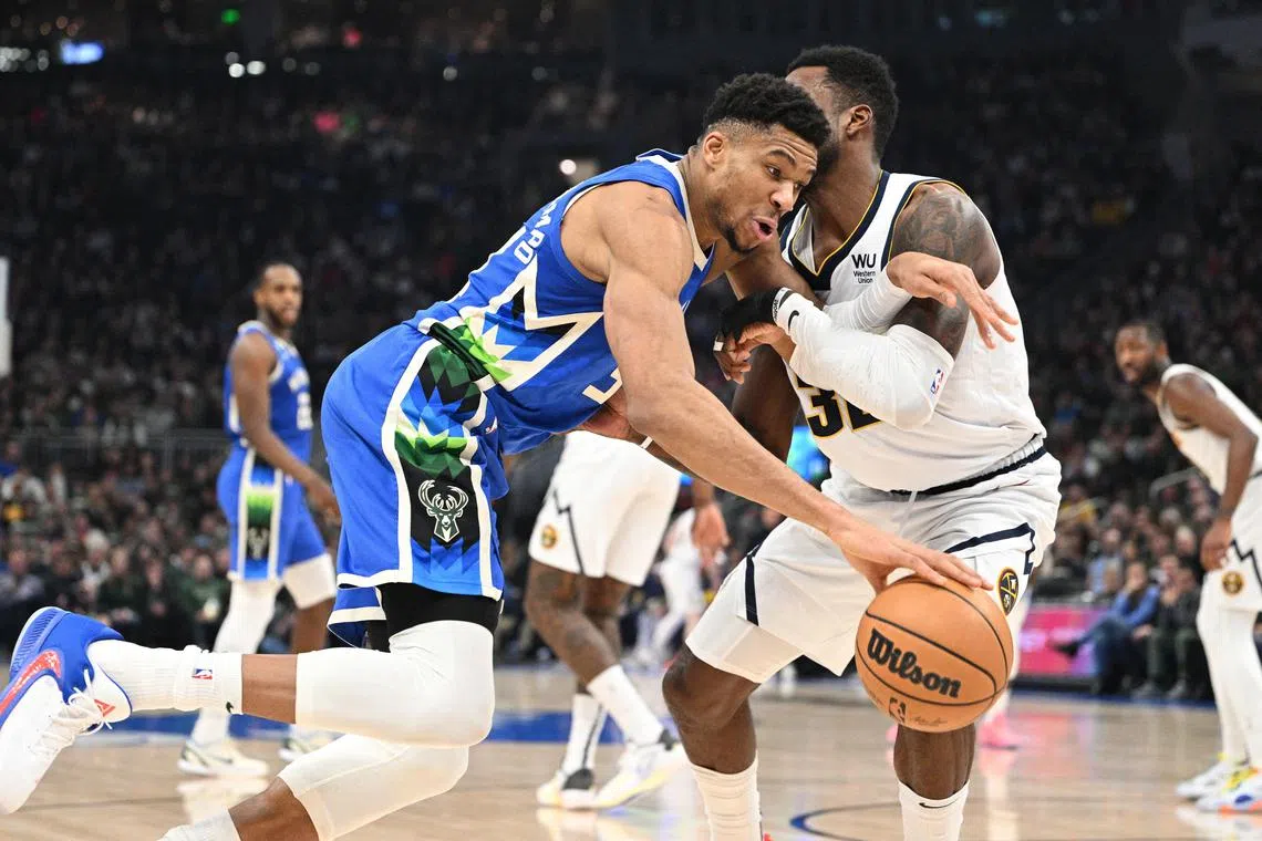 Milwaukee Bucks forward Giannis Antetokounmpo (34) drives to the basket against Denver Nuggets forward Jeff Green (32).