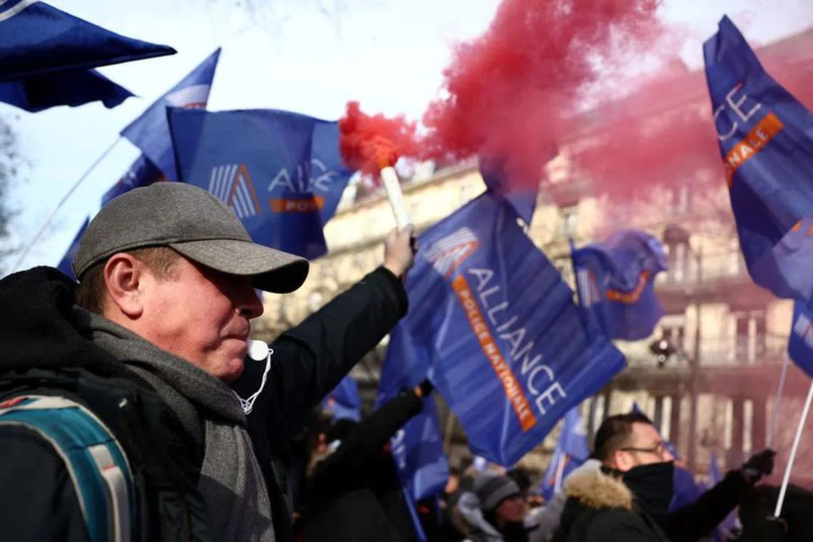 French police officers from the Alliance Police Nationale union hold flags during a demonstration to express their concerns and to demand compensation regarding the security of the Paris 2024 Olympic Games, in Paris, France, January 18, 2024. REUTERS/Stephanie Lecocq