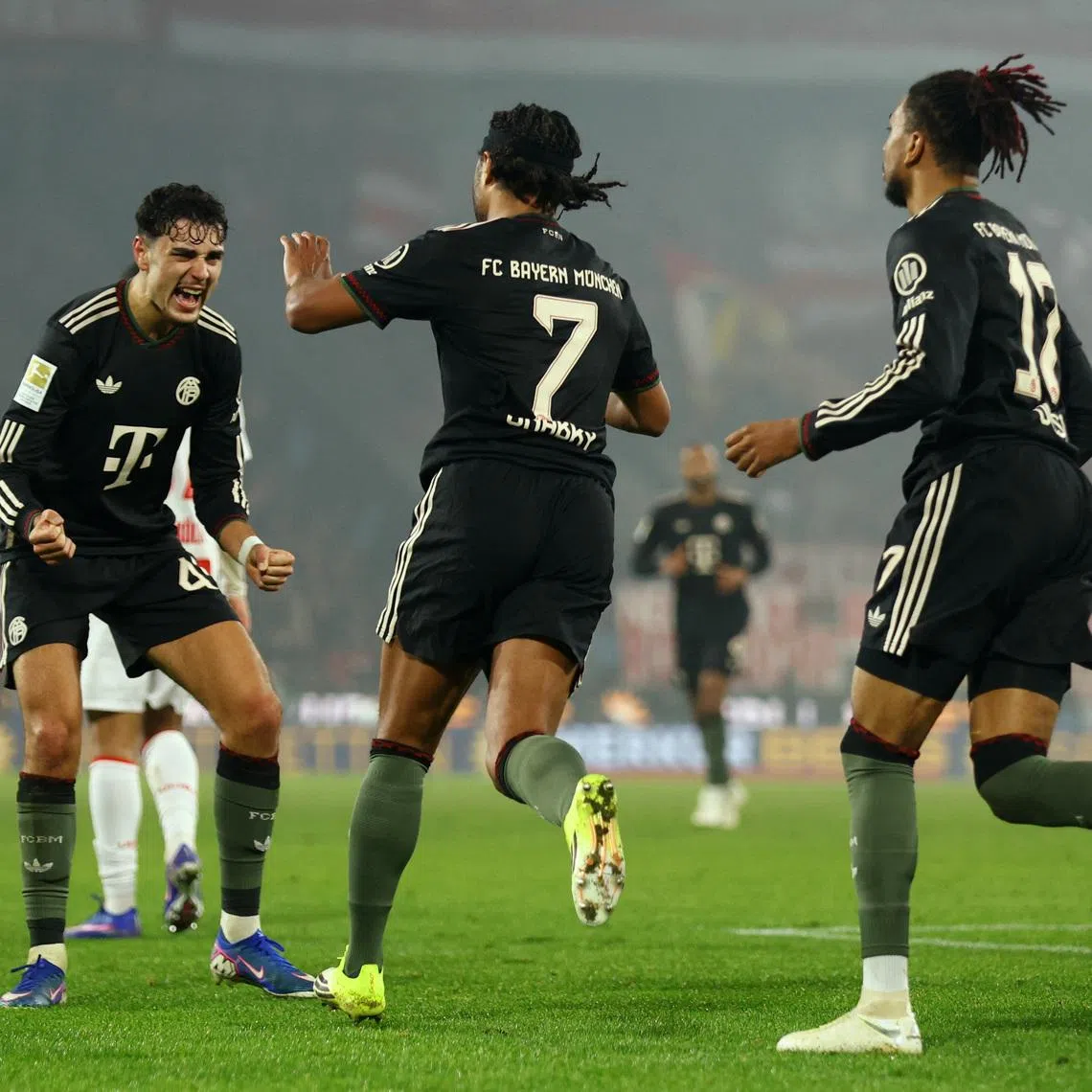 Soccer Football - Bundesliga - FC Cologne v Bayern Munich - RheinEnergieStadion, Cologne, Germany - January 14, 2026 Bayern Munich's Serge Gnabry celebrates scoring their first goal with teammates REUTERS/Thilo Schmuelgen