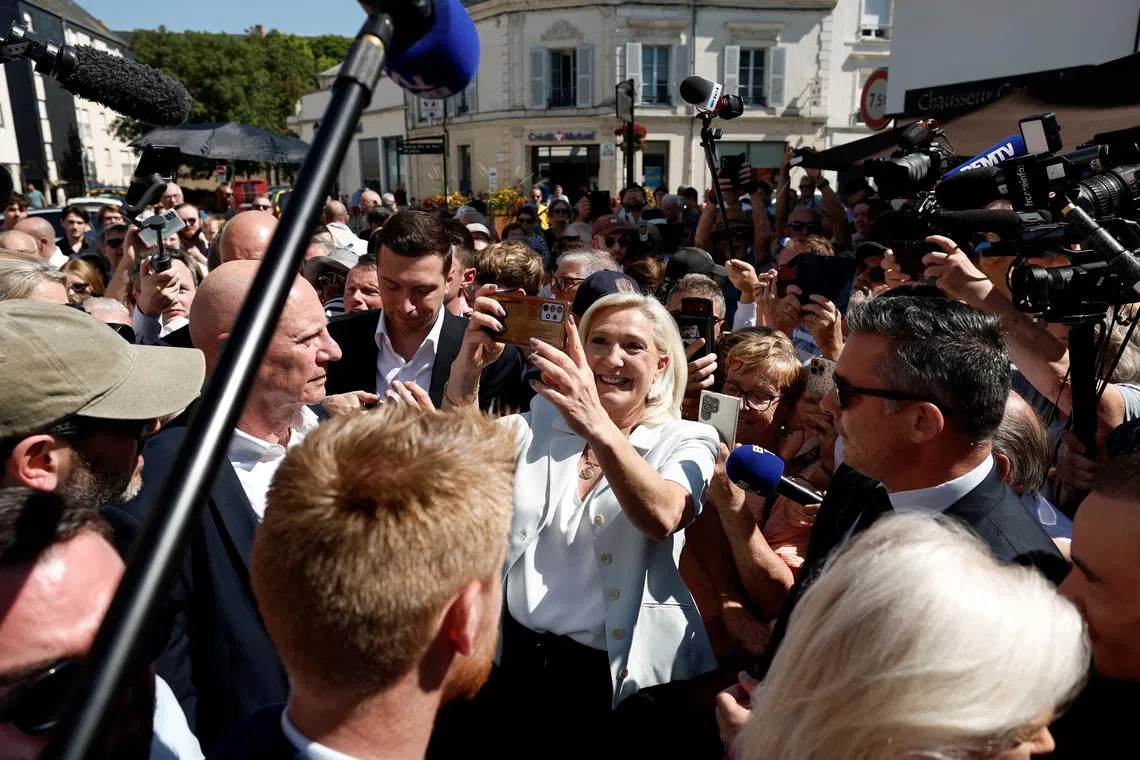 Cheers and boos for Le Pen's French campaign launch after guilty verdict