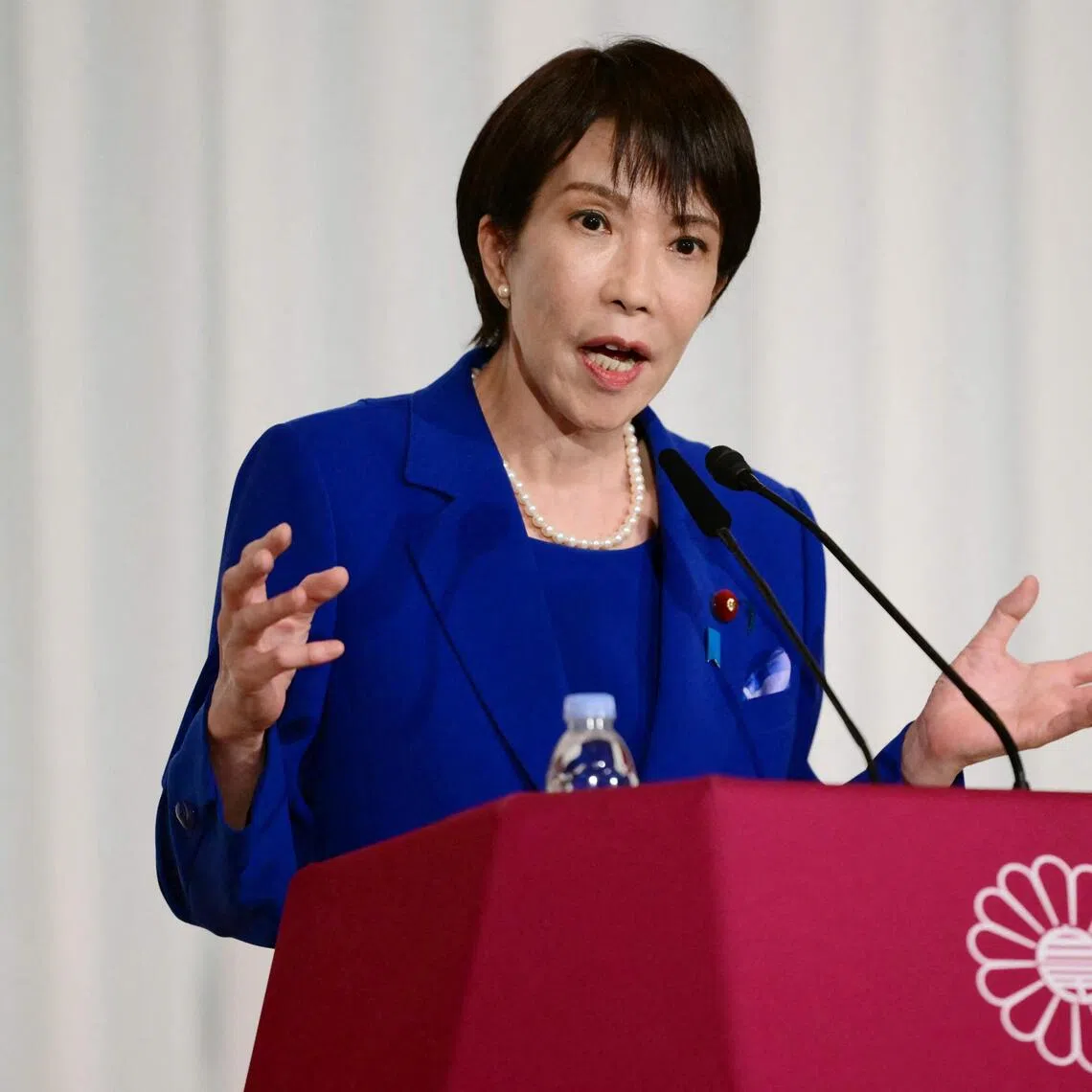 Sanae Takaichi, the newly-elected leader of Japan's ruling party, the Liberal Democratic Party (LDP), attends a press conference after the LDP presidential election in Tokyo on October 4, 2025. Conservative Sanae Takaichi hailed a "new era" on October 4 after winning the leadership of Japan's ruling party, putting her on course to become the country's first woman prime minister. (Photo by Yuichi YAMAZAKI / POOL / AFP)