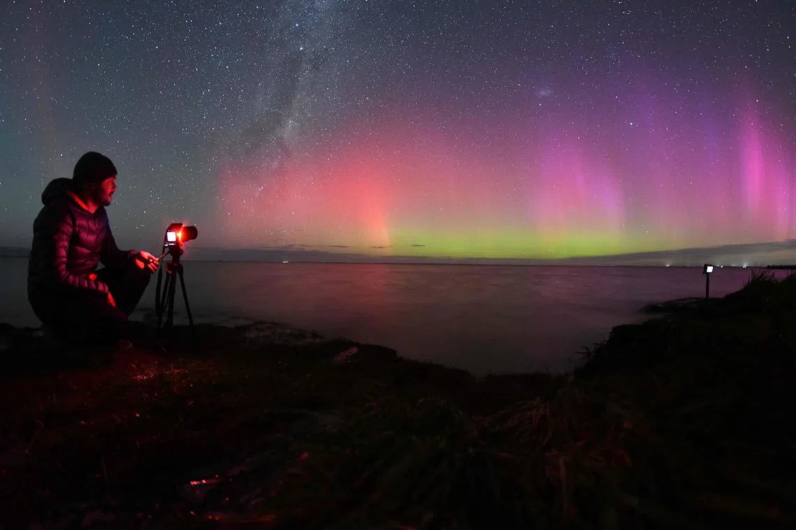 A photographer takes pictures of the Aurora Australis on the outskirts of Christchurch on April 24.