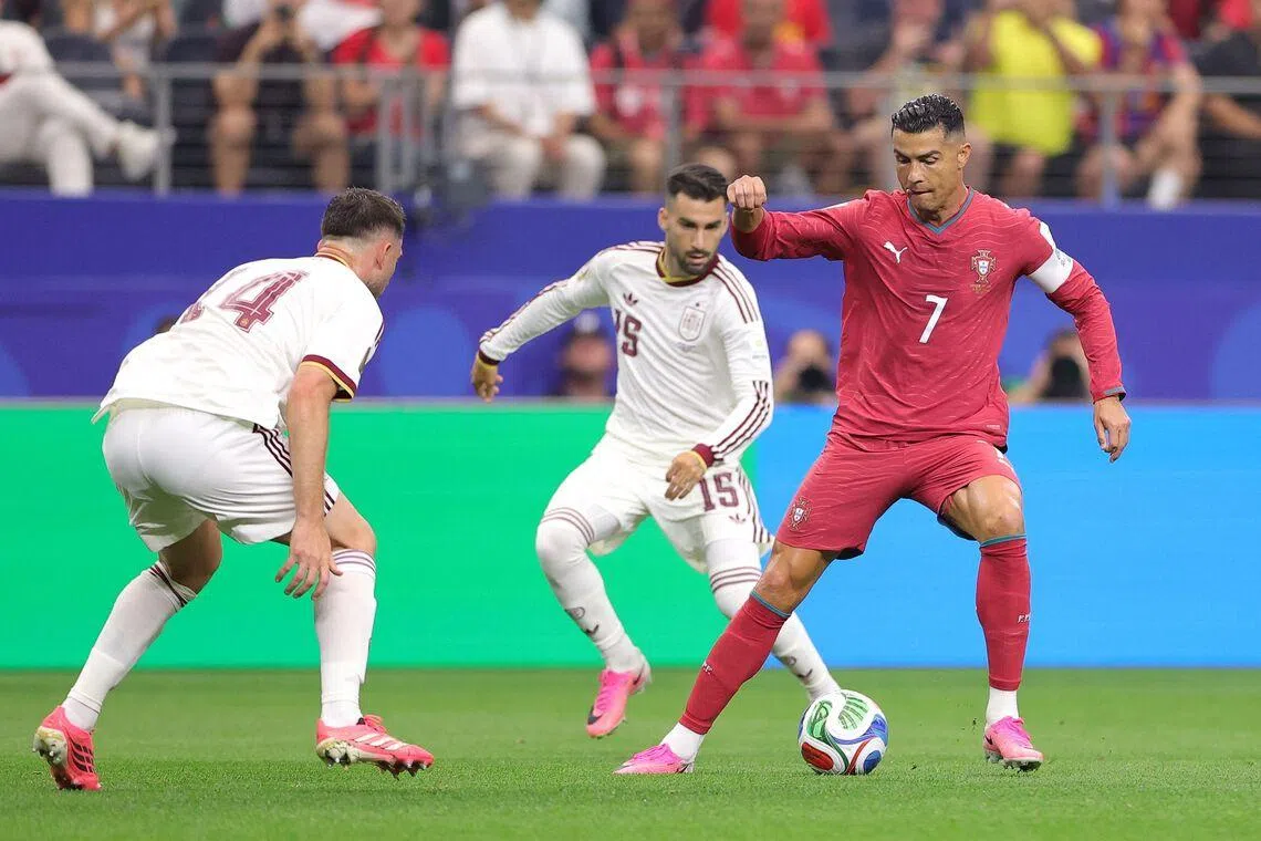 Cristiano Ronaldo (right) controls the ball against Spain’s Aymeric Laporte (left) and Alex Baena during the match on July 6.