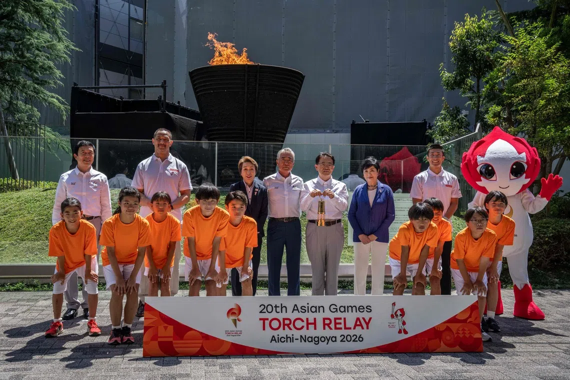 (Back L-R) Mayor of Nagoya Ichiro Hirosawa, former Japanese hammer throw athlete Koji Murofushi, President of the Japan Olympic Committee Seiko Hashimoto, Vice President of the Olympic Council of Asia Tsunekazu Takeda, Governor of Aichi Prefecture Hideaki Omura, Governor of Tokyo Yuriko Koike and Japanese sprinter Yoshihide Kiryu pose during the torch lighting ceremony for the 2026 Asian Games, outside the National Stadium in Tokyo on August 18, 2026. About 15,000 competitors and officials are expected at the event, which takes place in Nagoya and the wider Aichi area from September 19 to October 4. (Photo by Yuichi YAMAZAKI / AFP)