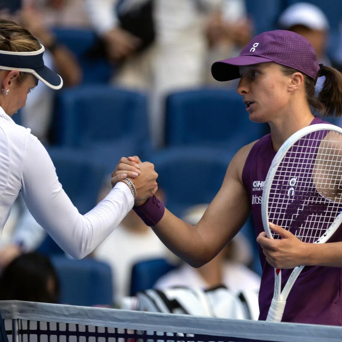 Poland’s Iga Swiatek (right) after coming from behind to beat Donna Vekic of Croatia in their China Open third-round match in Beijing on Oct 5.