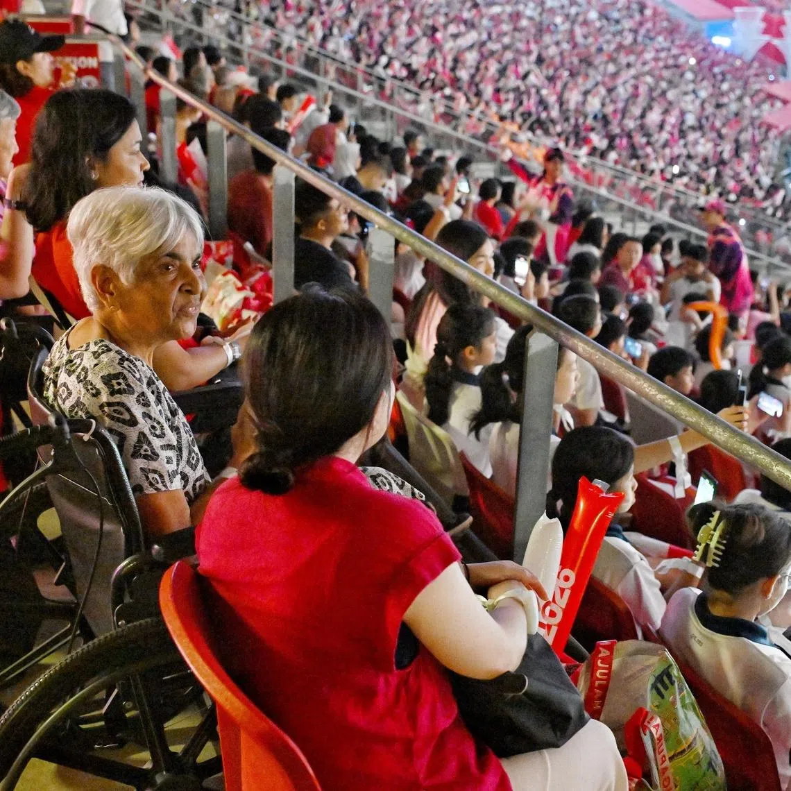 Innyria Gangataram (second from right), who uses a wheelchair, attending a full-dress rehearsal of this year’s National Day Parade at the National Stadium on July 18.