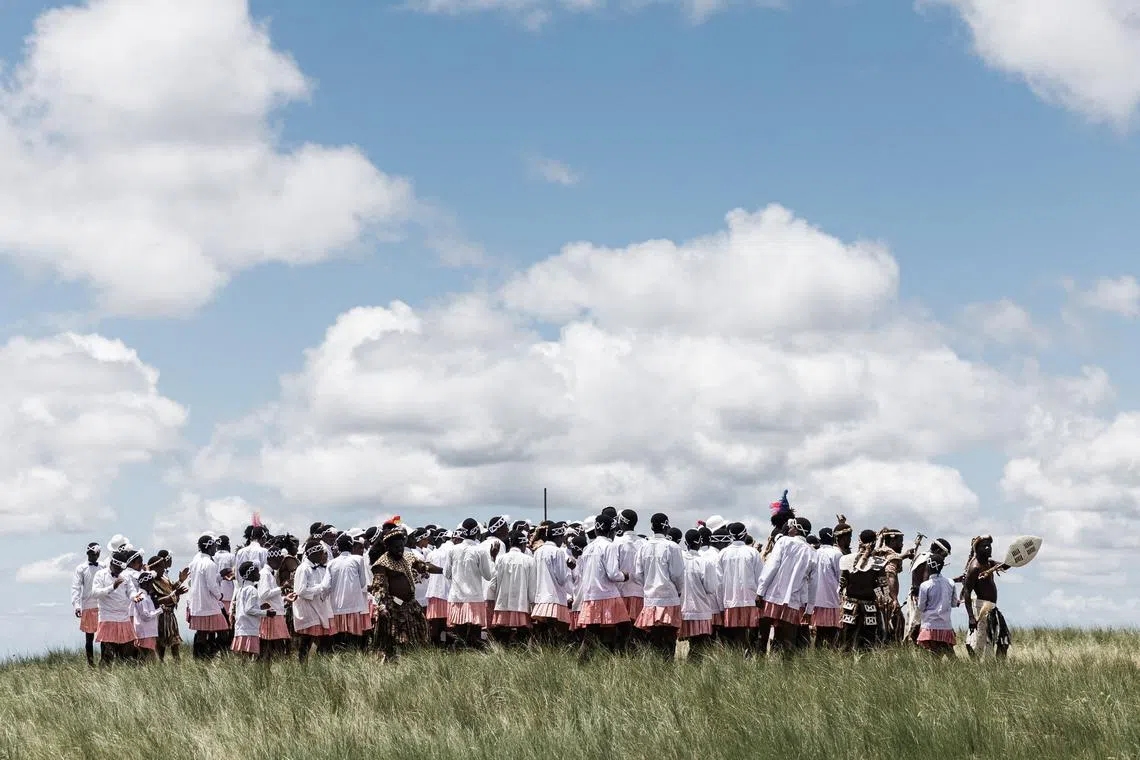 Followers of the Nazareth Baptist Church, from the Ekuphakameni group, also known as the Shembe Church, dressed in traditional attire, take part in a cultural dance on the Nhlangakazi Holy Mountain in Ndwedwe 85km north of Durban, on Jan 8, 2023. 