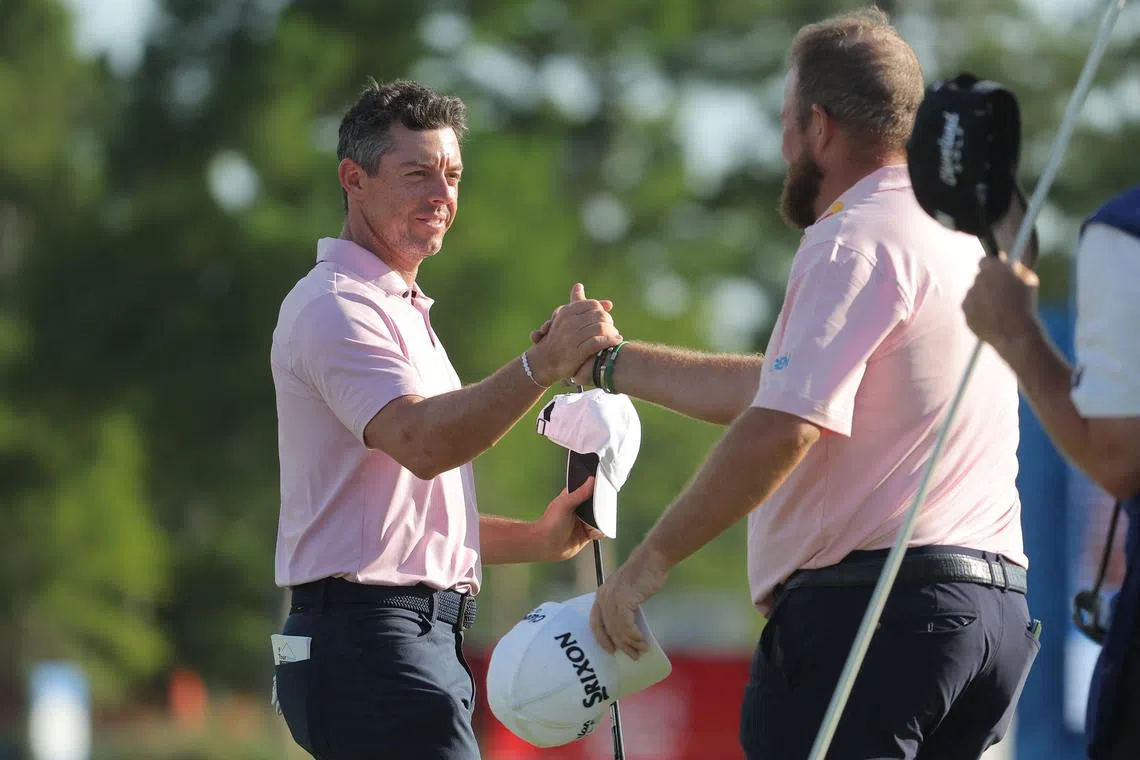 Rory McIlroy of Northern Ireland and Shane Lowry of Ireland on the 18th green during the first round of the Zurich Classic of New Orleans.
