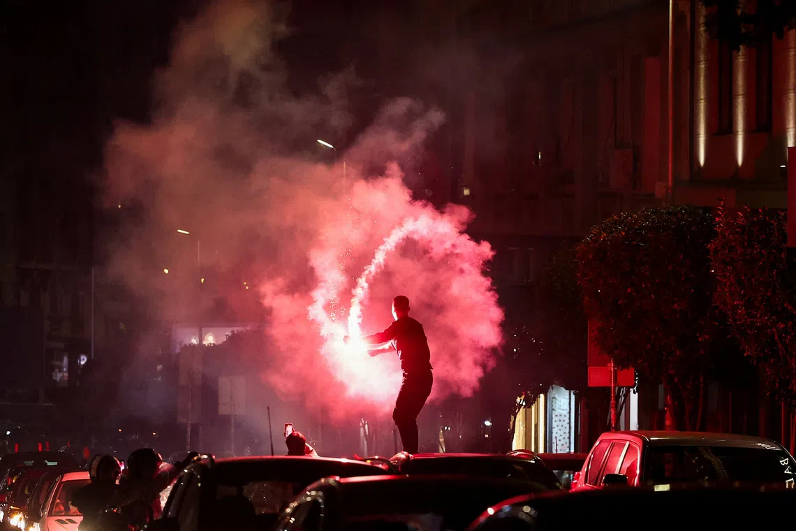A person lights a flare as supporters of the electoral list \"Student List - Students Win\" celebrate following the first results of the parliamentary election in Belgrade, Serbia, October 25, 2026. REUTERS/Zorana Jevtic