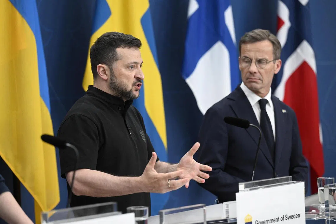 Ukrainian President Volodymyr Zelensky speaking at a press conference in Stockholm, as Swedish Prime Minister Ulf Kristersson listens.